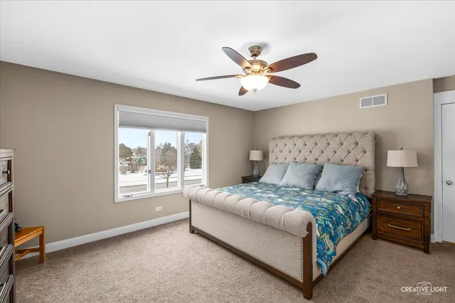 a bedroom with a large bed and a window