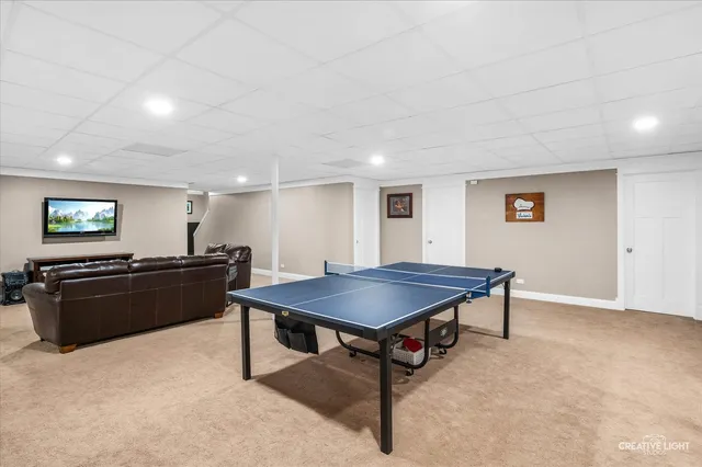 a living room with a table and a flat screen tv
