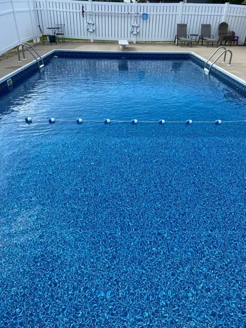 a view of a house with pool and a chairs