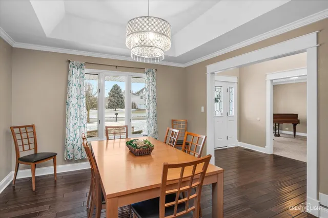 a view of a dining room with furniture wooden floor and chandelier