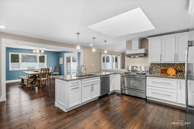 a kitchen with white cabinets and appliances