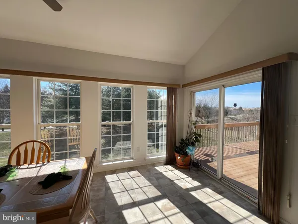 a view of a balcony with chair and the glass door