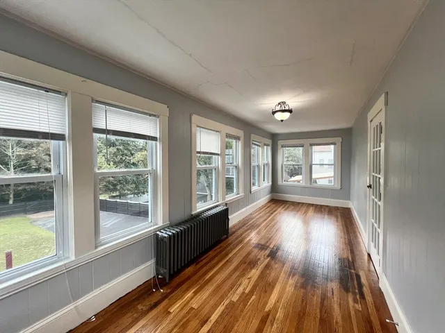 a view of hallway with wooden floor