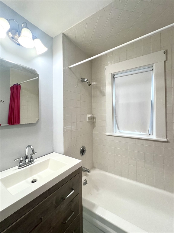 79 Franklin Street, Unit 2 Stoneham, MA 02180 - Photo 16 of 16 a bathroom with a tub sink and mirror