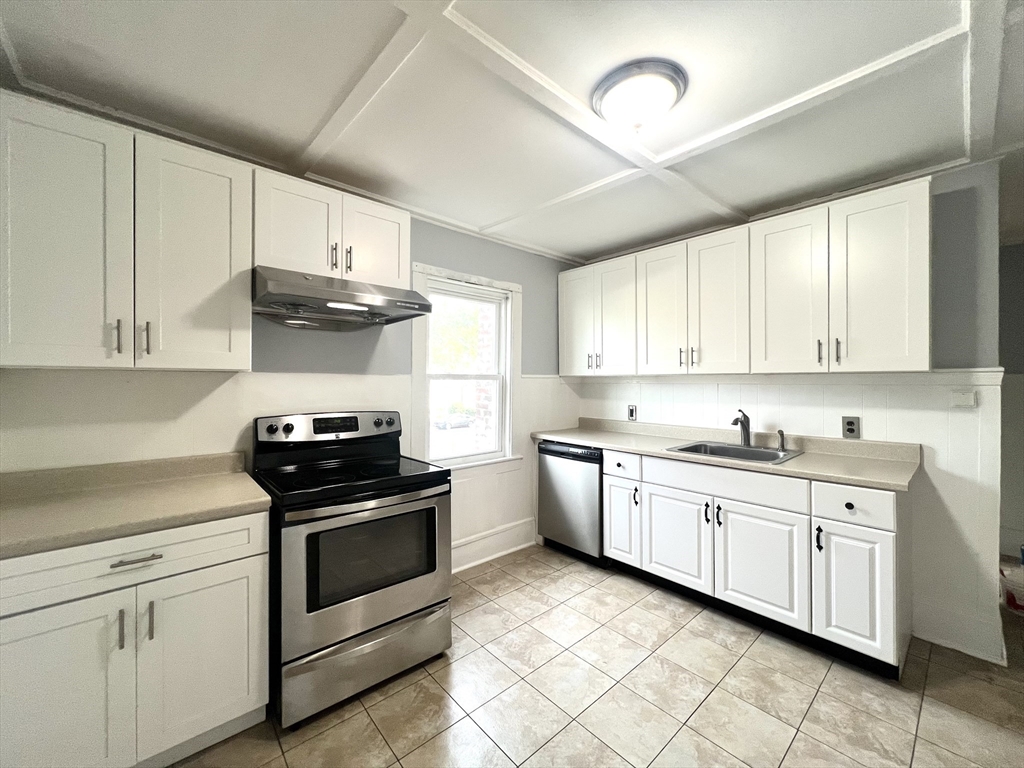 79 Franklin Street, Unit 2 Stoneham, MA 02180 - Photo 7 of 16 a kitchen with cabinets appliances and a sink