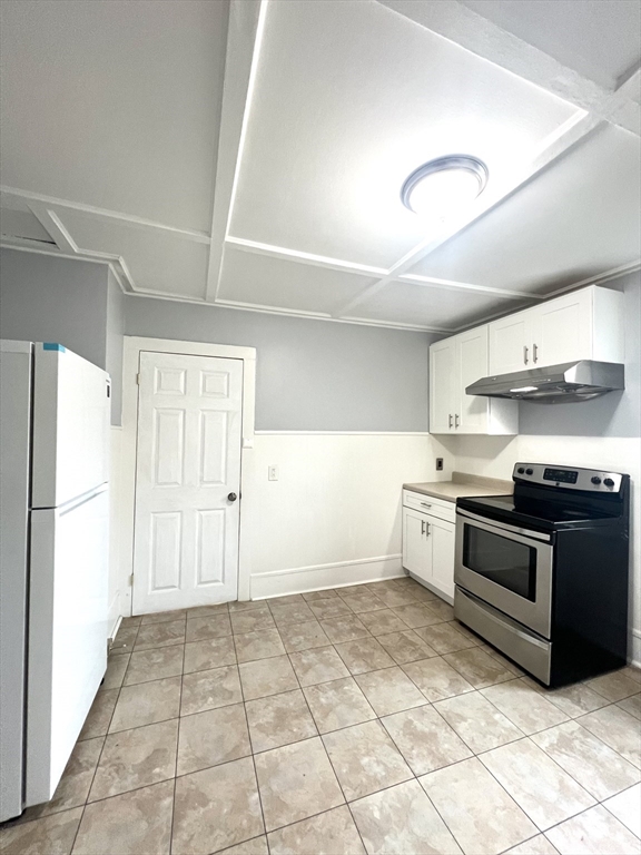 79 Franklin Street, Unit 2 Stoneham, MA 02180 - Photo 8 of 16 a kitchen with stainless steel appliances granite countertop a refrigerator and a stove