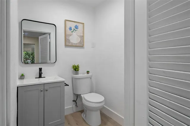 a bathroom with a toilet a sink and mirror