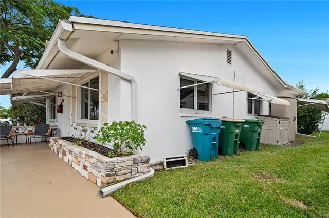 a front view of house with yard and outdoor seating
