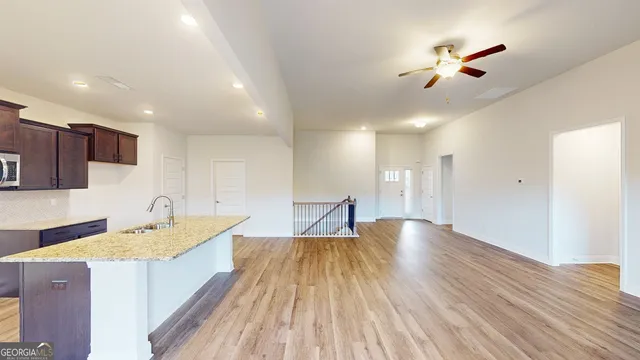 a spacious bathroom with a granite countertop sink and a large mirror
