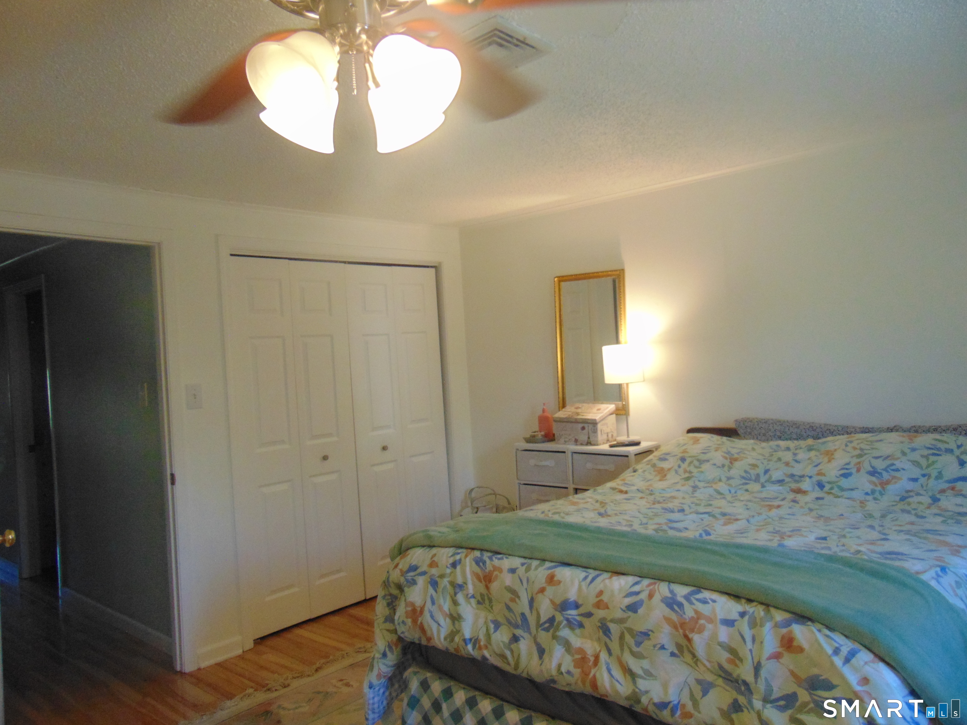 882 North Colony Road, Unit 31 Meriden, CT 06450 - Photo 32 of 34 a bedroom with a bed and a chandelier