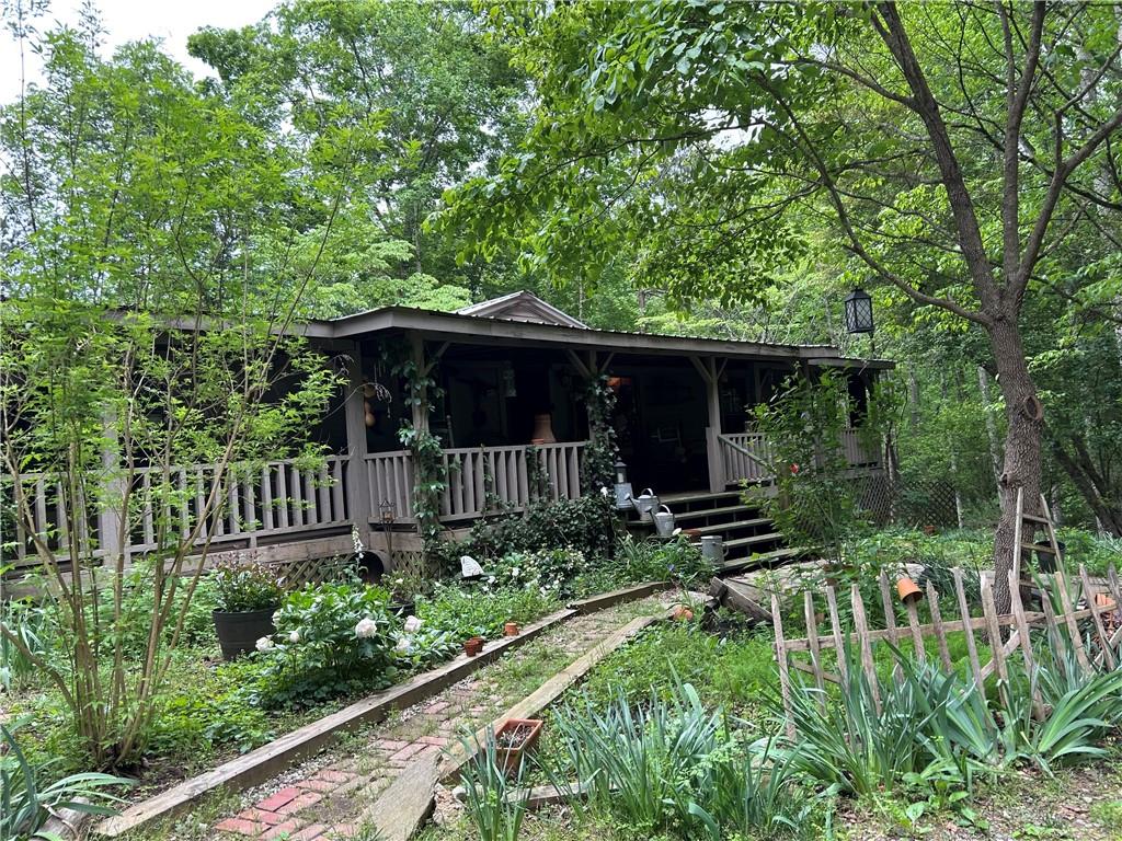 a view of backyard with small garden and seating area