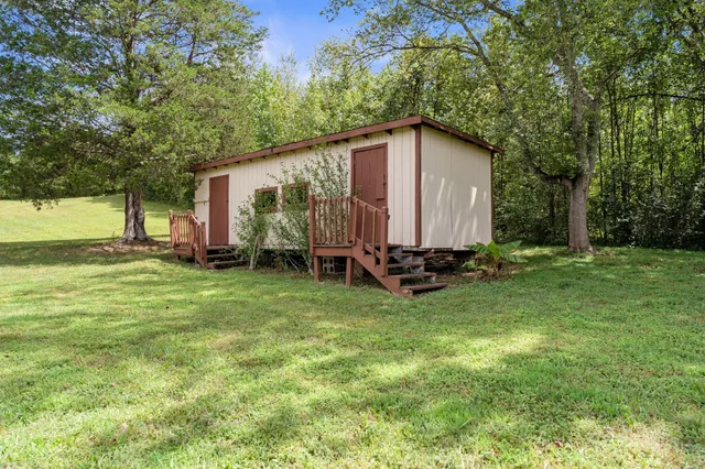 a view of backyard with garden and deck