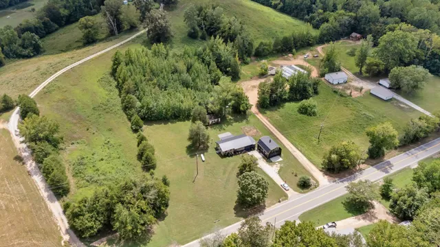 an aerial view of a house with a yard