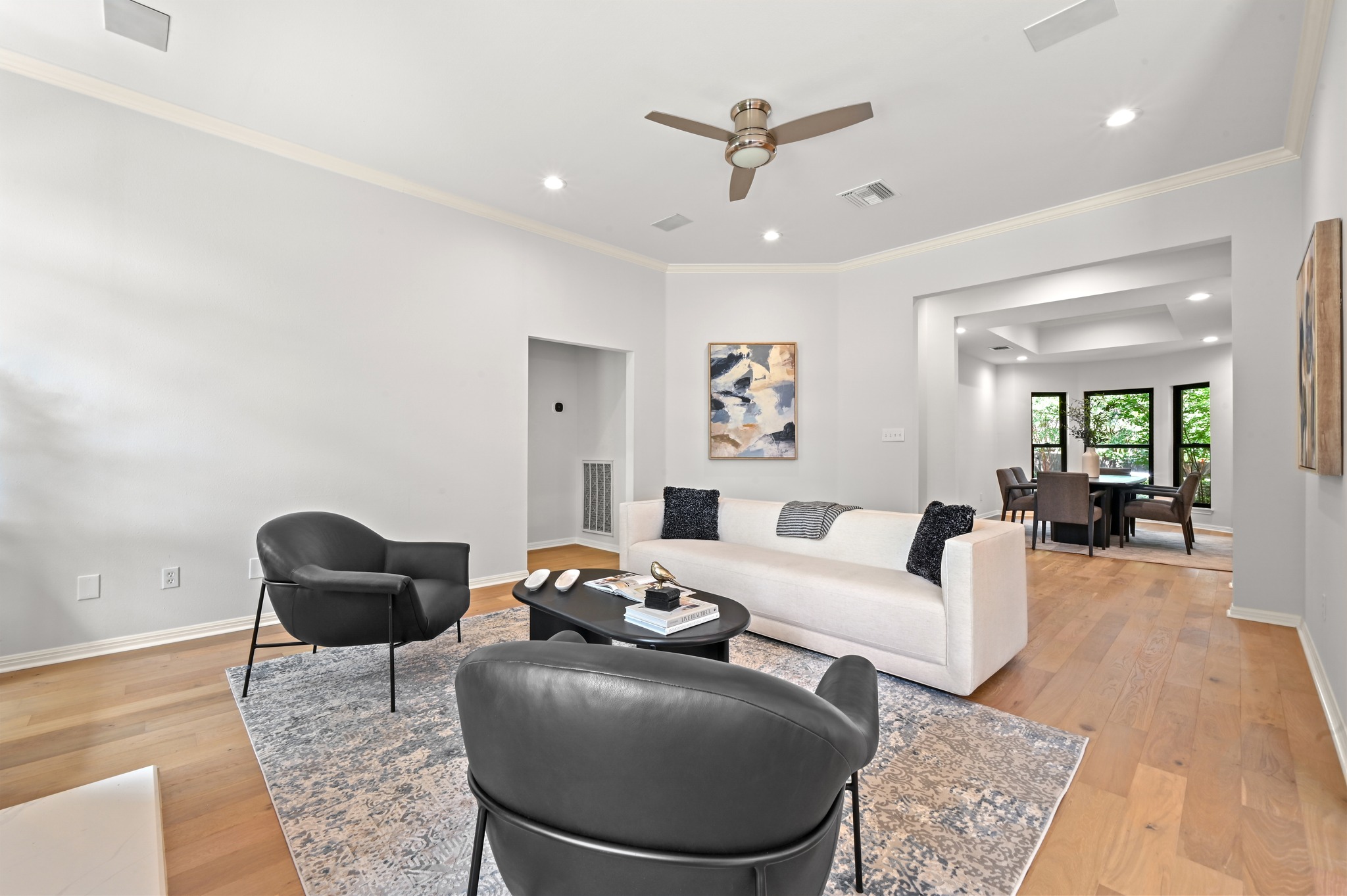 1107 Bowie Road Austin, TX 78733 - Photo 13 of 40 An inviting living area with a ceiling fan, recessed lighting, and light hardwood flooring.