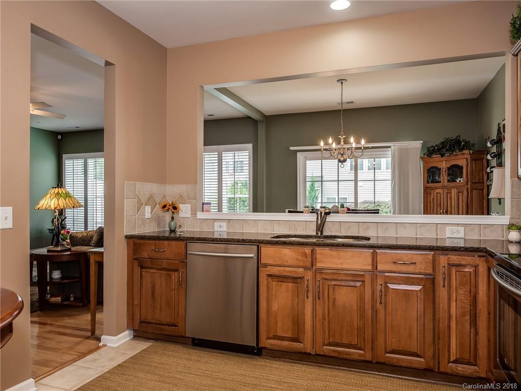 9176 Redmond Trace Road Charlotte, NC 28277 - Photo 11 of 24 a kitchen with granite countertop a sink and cabinets