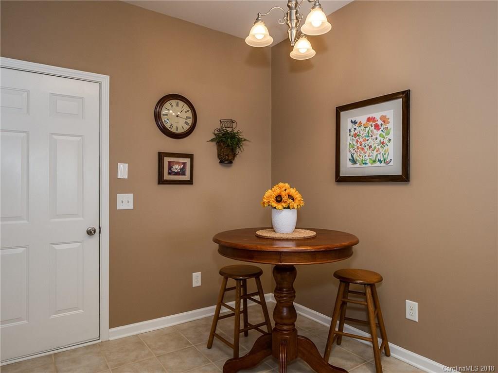 9176 Redmond Trace Road Charlotte, NC 28277 - Photo 12 of 24 a view of a dining room with furniture and a chandelier fan