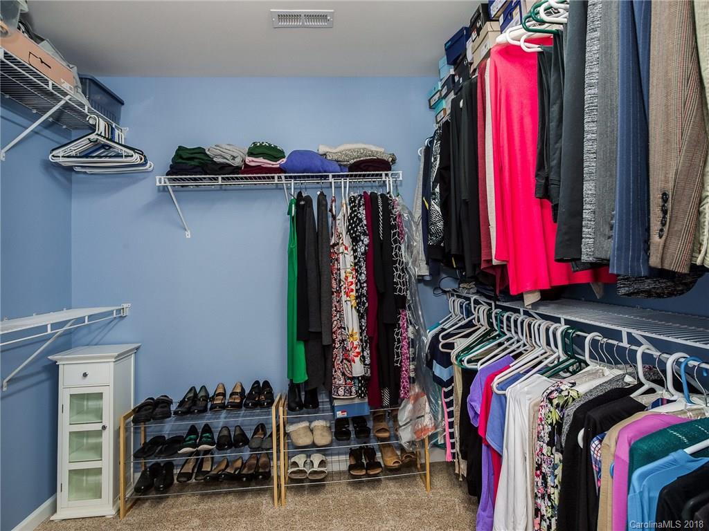 9176 Redmond Trace Road Charlotte, NC 28277 - Photo 16 of 24 a view of walk in closet with clothes and shoes