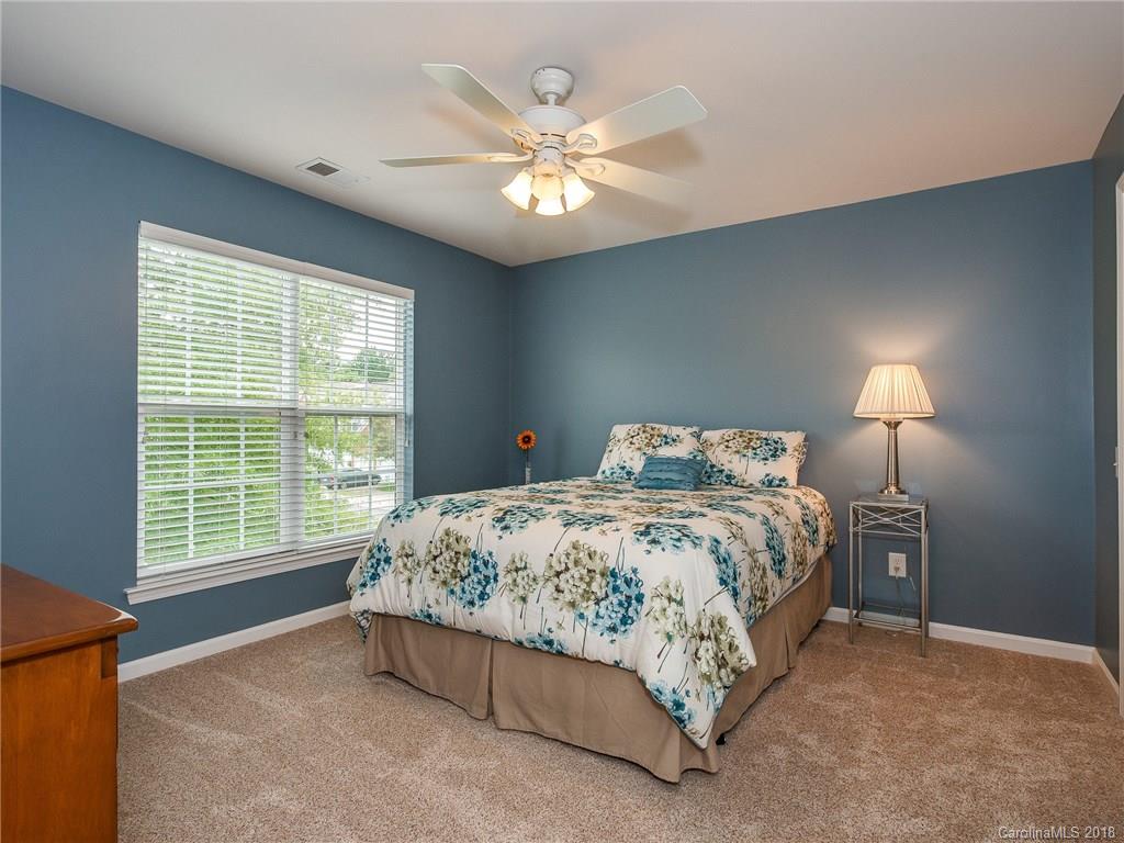 9176 Redmond Trace Road Charlotte, NC 28277 - Photo 17 of 24 a bedroom with a bed and a large window