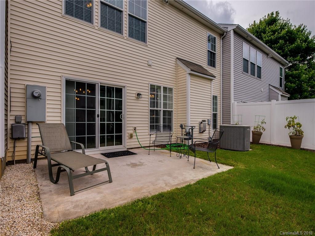 9176 Redmond Trace Road Charlotte, NC 28277 - Photo 22 of 24 a view of a patio with a table and chairs