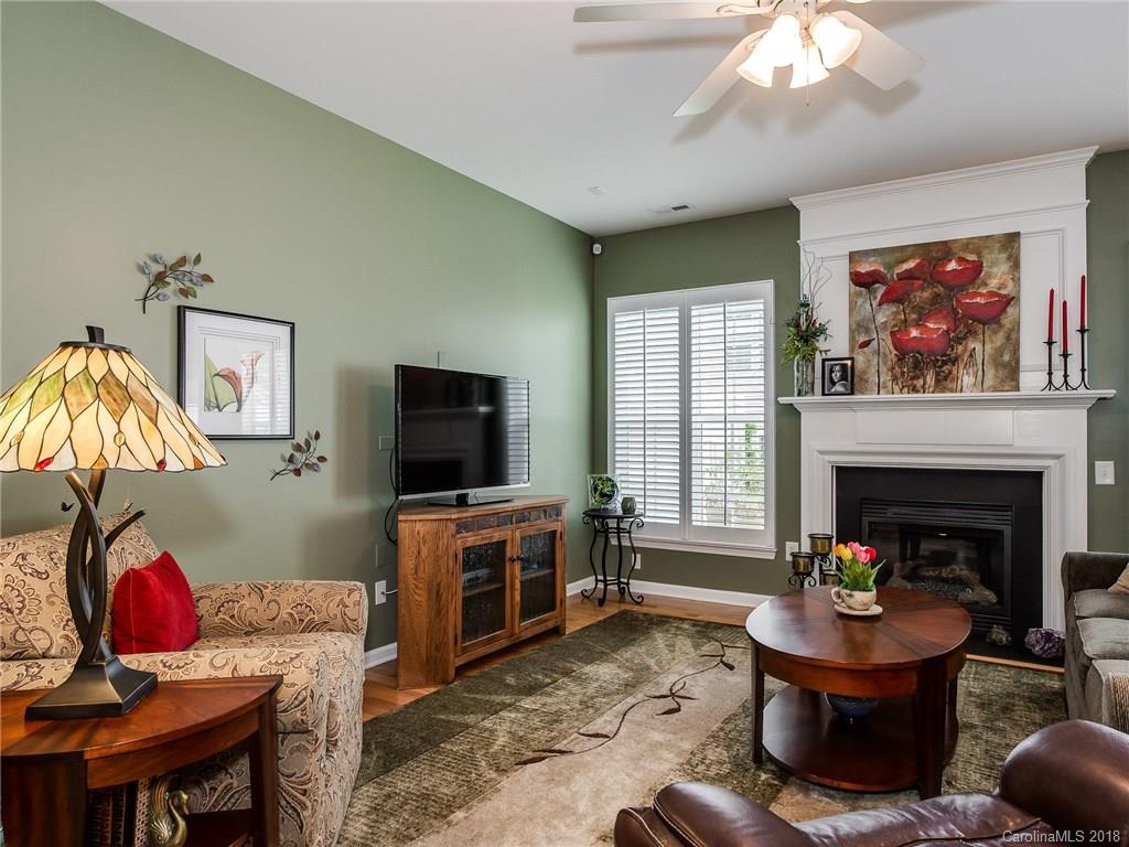 9176 Redmond Trace Road Charlotte, NC 28277 - Photo 5 of 24 a living room with furniture a flat screen tv and a fireplace