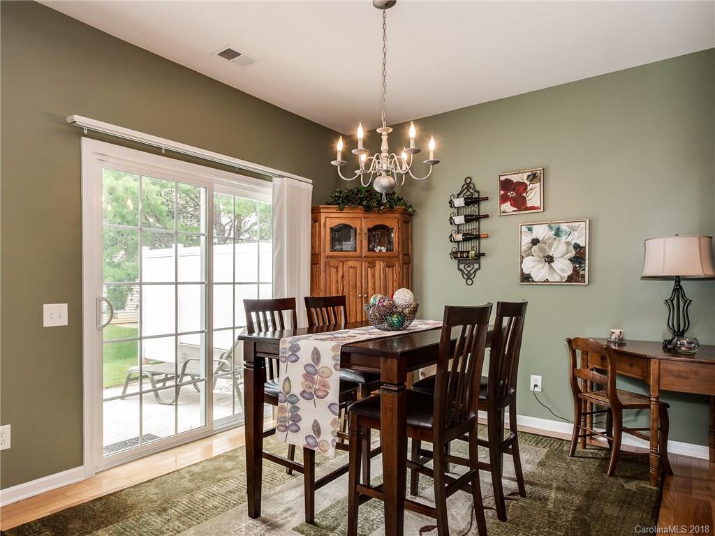 9176 Redmond Trace Road Charlotte, NC 28277 - Photo 6 of 24 a view of a dining room with furniture a chandelier and wooden floor