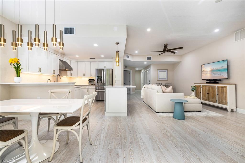 19071 Ridgepoint Drive, Unit 102 Estero, FL 33928 - Photo 11 of 50 a living room with furniture and a wooden floor