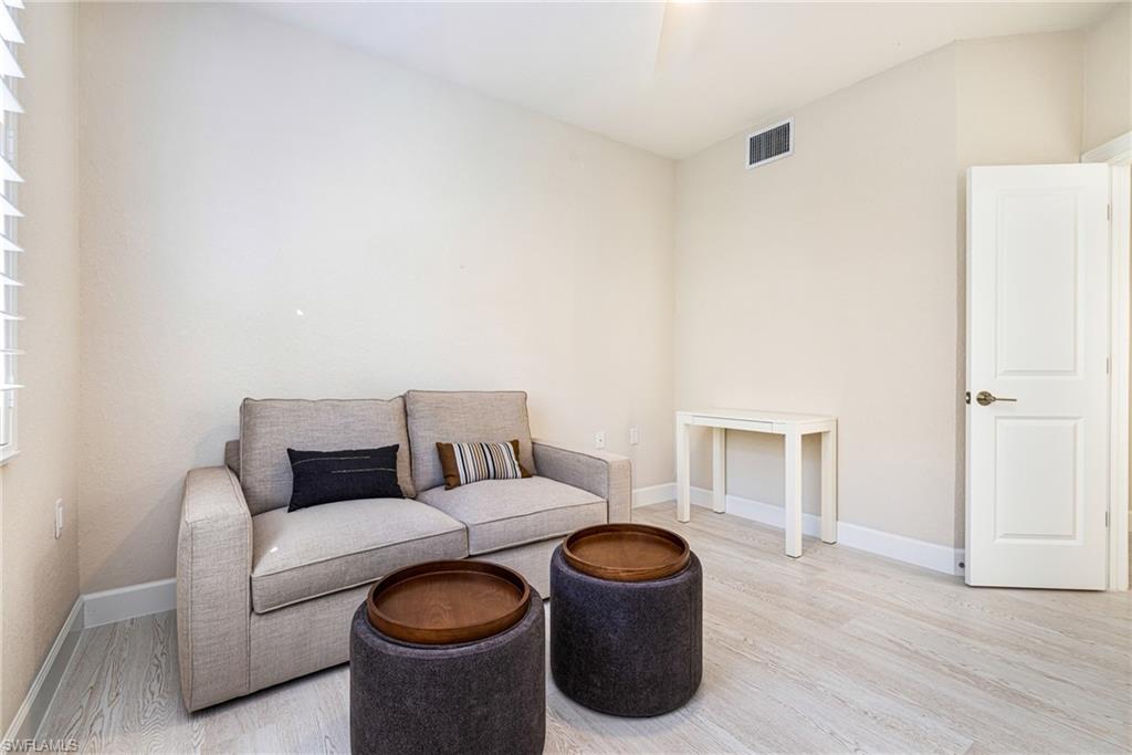 19071 Ridgepoint Drive, Unit 102 Estero, FL 33928 - Photo 16 of 50 a living room with furniture a couch and wooden floor
