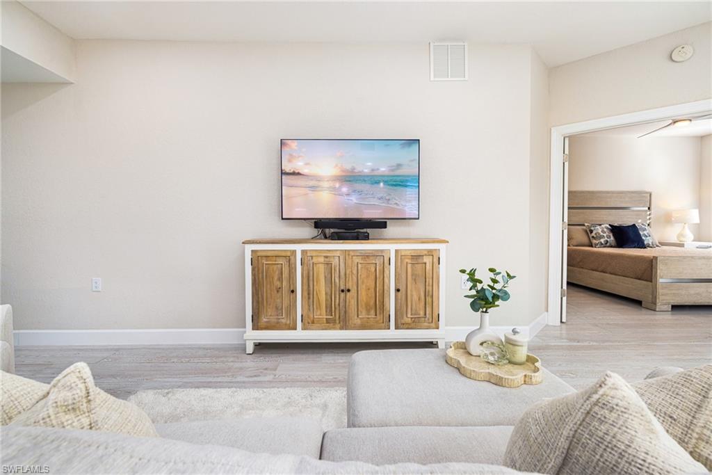 19071 Ridgepoint Drive, Unit 102 Estero, FL 33928 - Photo 2 of 50 a living room with furniture and a flat screen tv