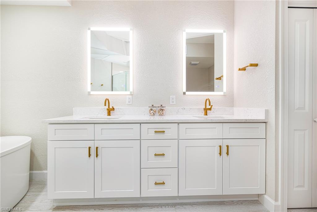 19071 Ridgepoint Drive, Unit 102 Estero, FL 33928 - Photo 21 of 50 a bathroom with a sink vanity and toilet