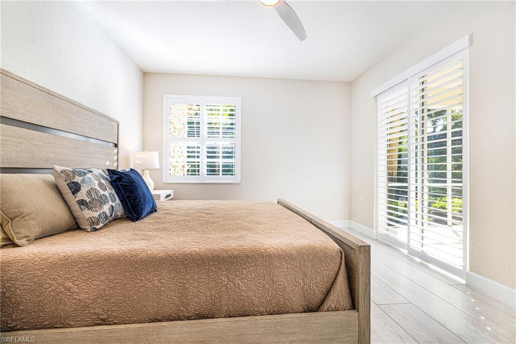 19071 Ridgepoint Drive, Unit 102 Estero, FL 33928 - Photo 25 of 50 a large bed sitting in a bedroom next to a window