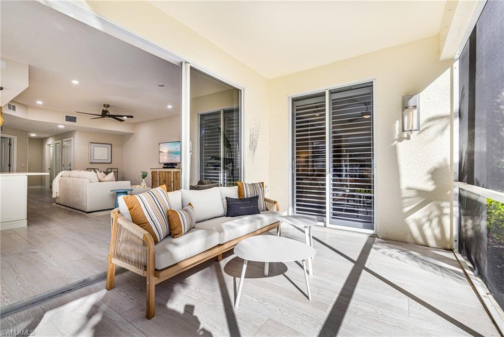 19071 Ridgepoint Drive, Unit 102 Estero, FL 33928 - Photo 30 of 50 a living room with furniture and a large window