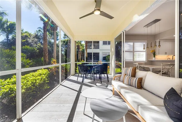 a view of a patio with couches potted plants and wooden floor