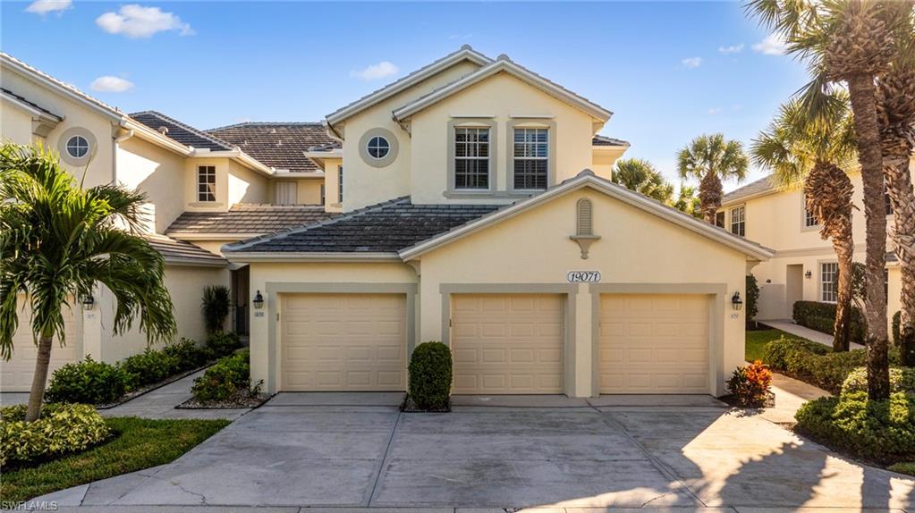 19071 Ridgepoint Drive, Unit 102 Estero, FL 33928 - Photo 34 of 50 a view of a house with a yard and potted plants