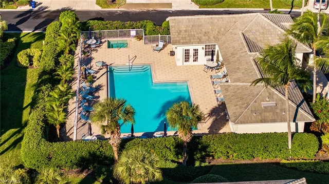 an aerial view of residential houses with outdoor space and swimming pool