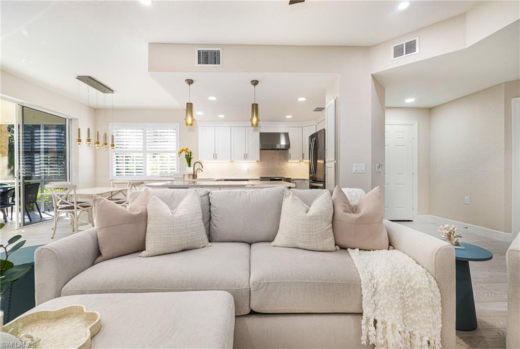 19071 Ridgepoint Drive, Unit 102 Estero, FL 33928 - Photo 4 of 50 a living room with furniture and kitchen view