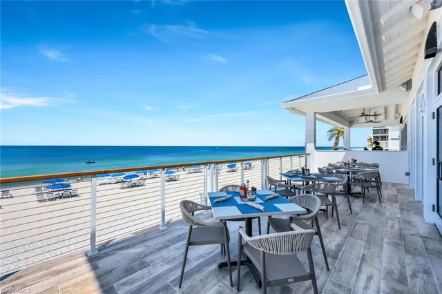 a living room with lots of furniture and a large window