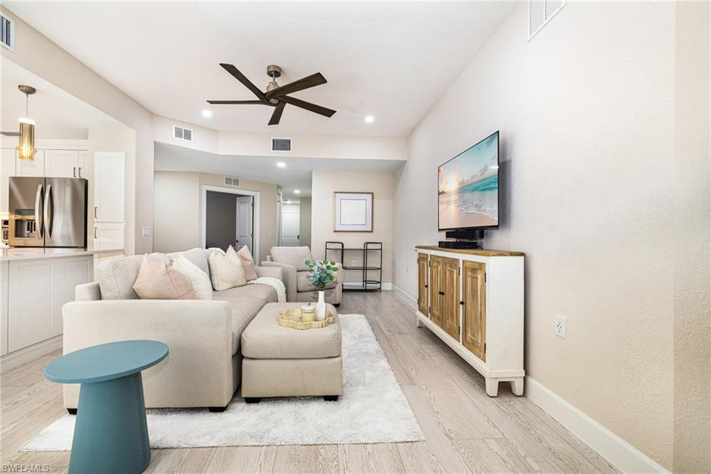19071 Ridgepoint Drive, Unit 102 Estero, FL 33928 - Photo 5 of 50 a living room with furniture and a flat screen tv