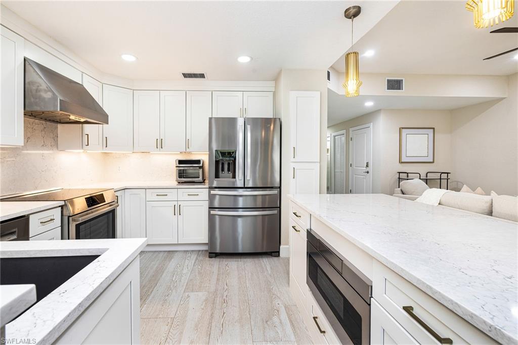 19071 Ridgepoint Drive, Unit 102 Estero, FL 33928 - Photo 6 of 50 a kitchen with a sink stove and refrigerator