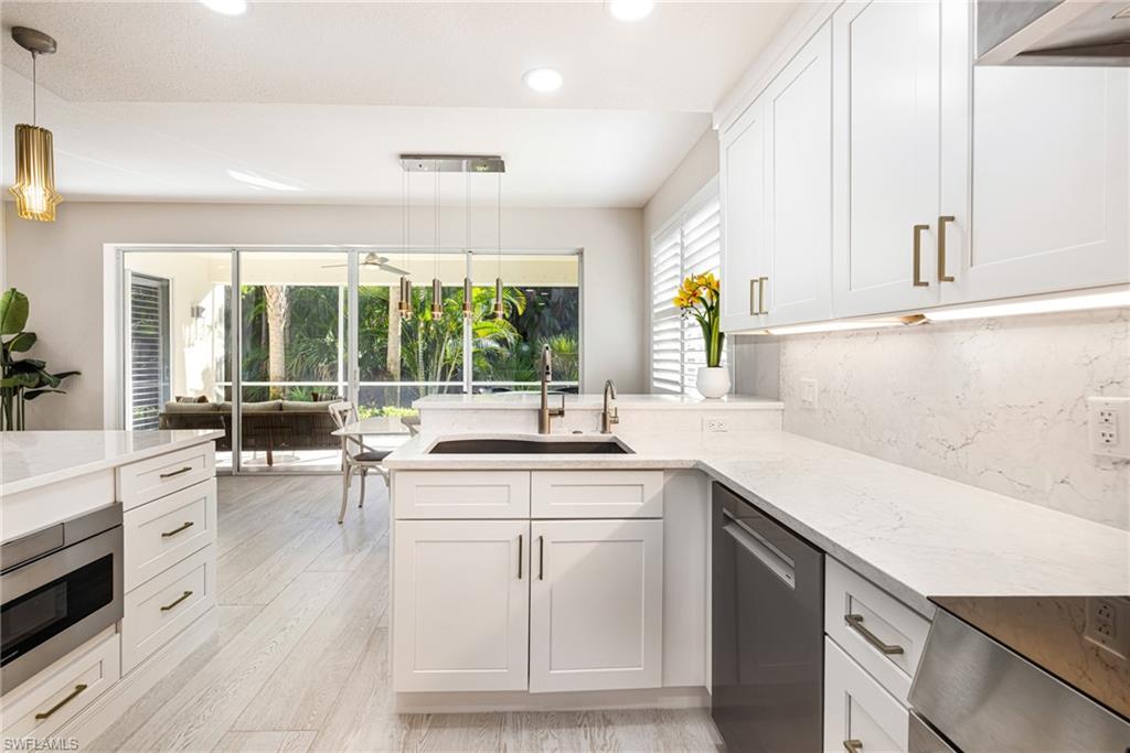 19071 Ridgepoint Drive, Unit 102 Estero, FL 33928 - Photo 8 of 50 a kitchen with sink and cabinets