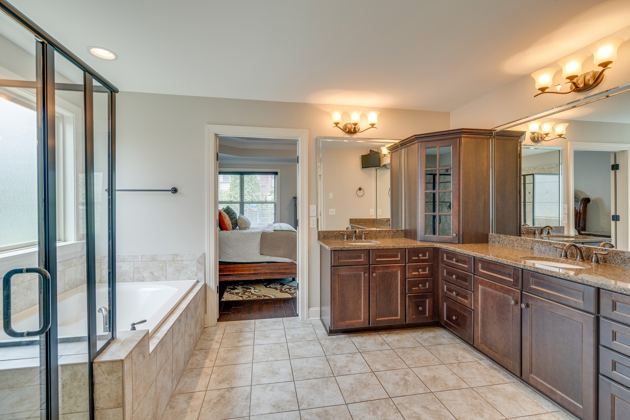 5108 Mountainbrook Circle Hermitage, TN 37076 - Photo 19 of 43 a large en suite bathroom with a double vanity sink a large mirror and a bathtub