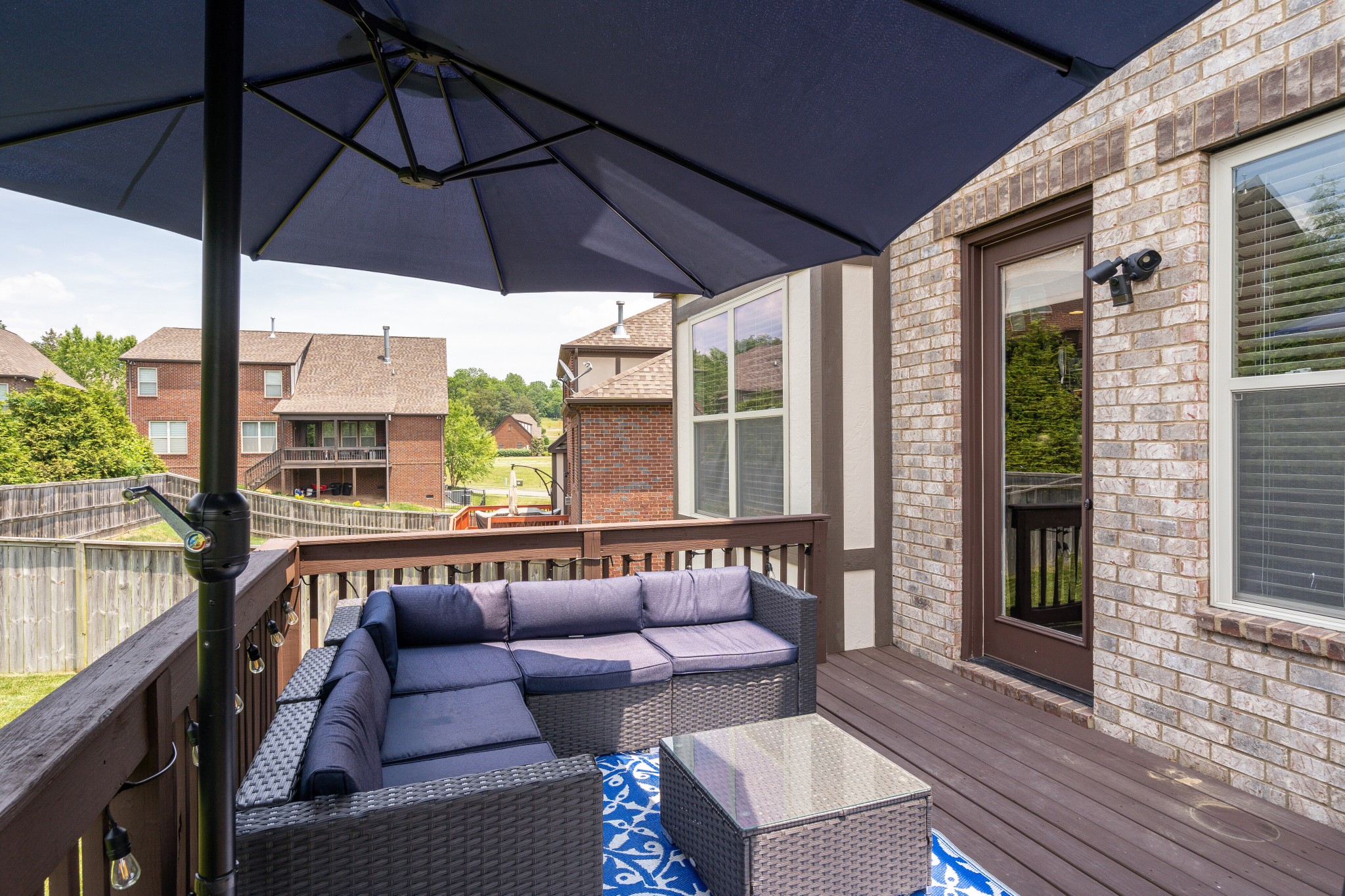 5108 Mountainbrook Circle Hermitage, TN 37076 - Photo 30 of 43 a roof deck with a table and chairs under an umbrella