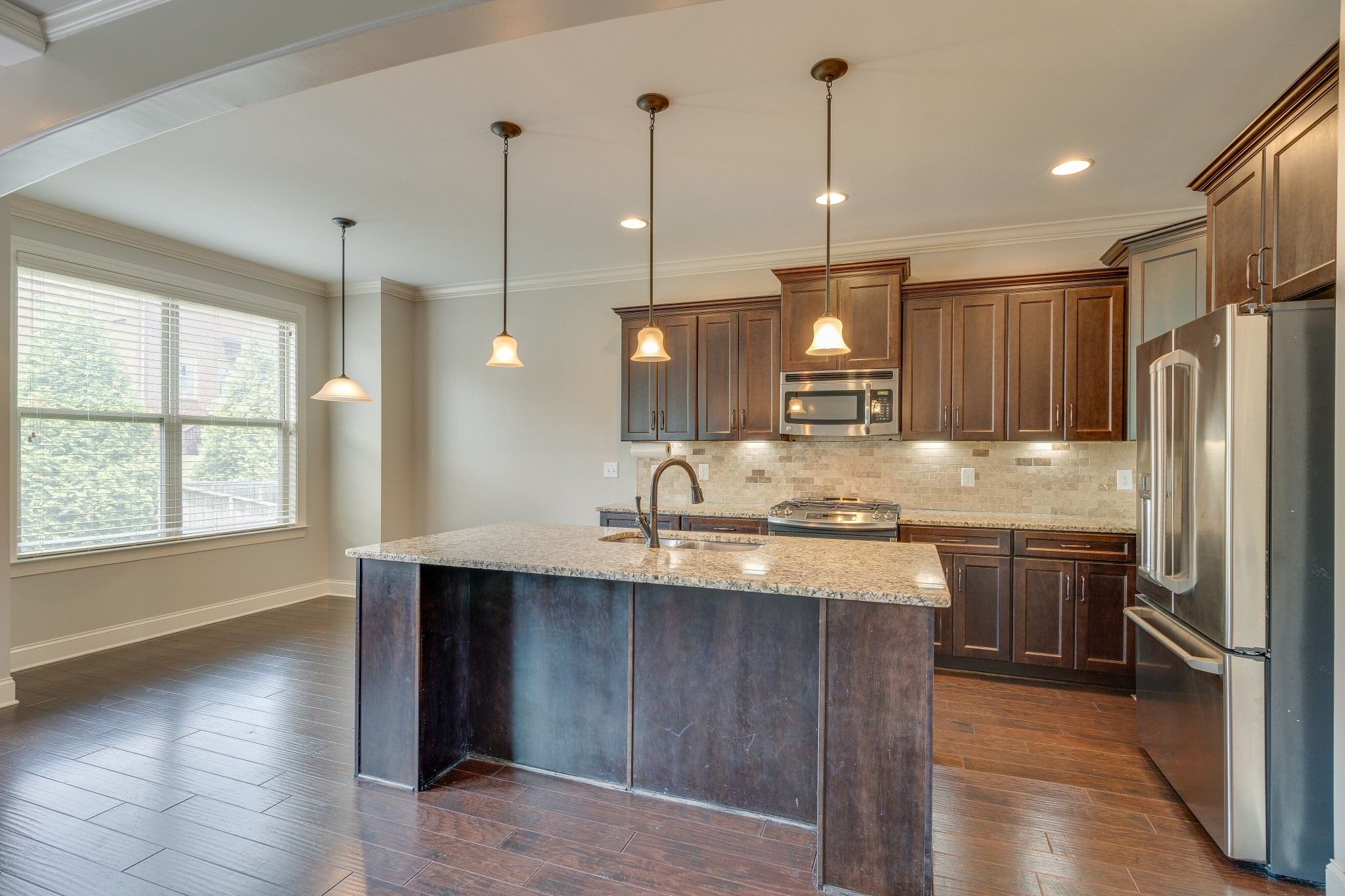 5108 Mountainbrook Circle Hermitage, TN 37076 - Photo 10 of 43 a kitchen with kitchen island granite countertop wooden cabinets and a refrigerator