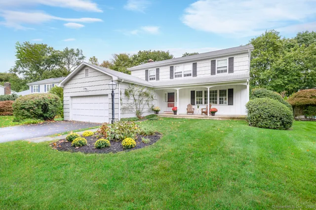 a view of a house with a backyard and a patio