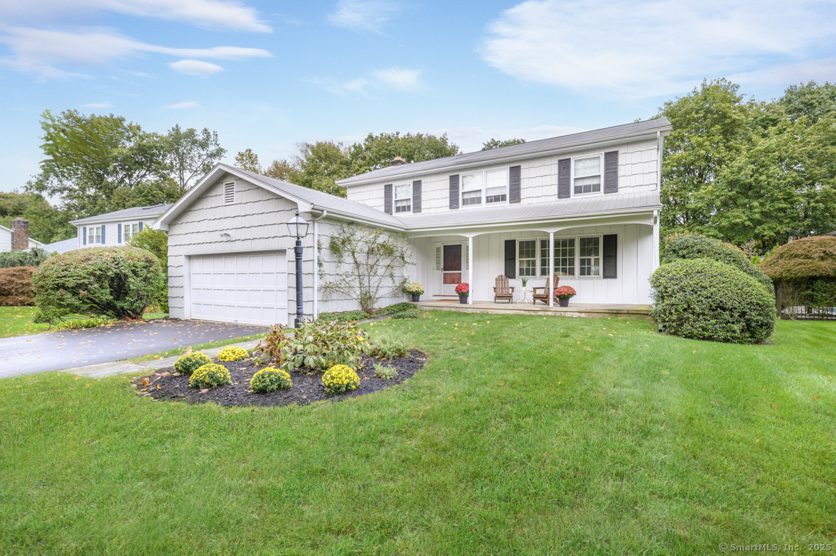 a view of a house with a backyard and a patio