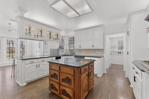 a kitchen with granite countertop a sink and a stove top oven