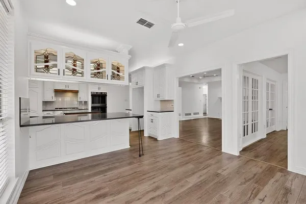 a view of a kitchen with wooden floor and a kitchen