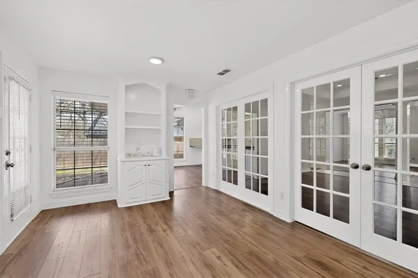 a view of wooden floor and windows in a room