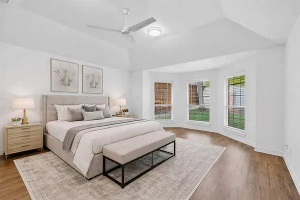 a spacious bedroom with a large bed and a window