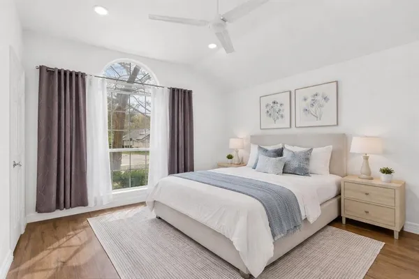 a bedroom with a large bed and a large window