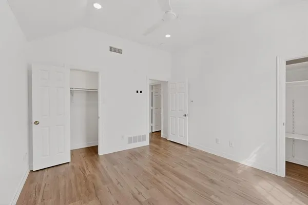 a view of an empty room with wooden floor